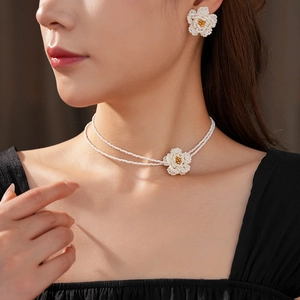 Detail of double-layer woven white seed bead camellia flower necklace and earrings set