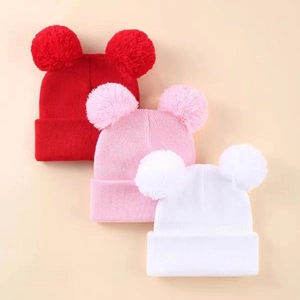 Set of three cozy knitted hats with double pom-poms for kids in red, pink and white