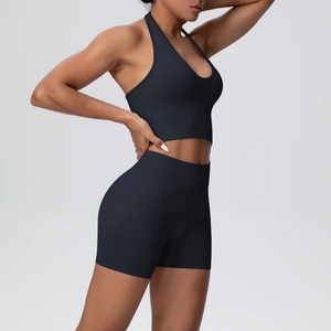 Detail of seamless knit yoga set showing V-neck crop top and high waist sports shorts