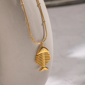 Elegante collana a lisca di pesce dorata con cristallo e catena a palline
