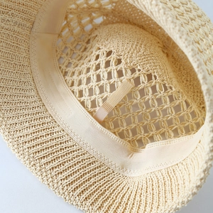Detail shot of straw bucket hat interior featuring sweatband and adjustable drawstring
