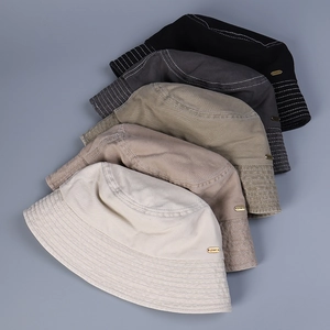 Close-up of bucket hats in five colors with JHMY metal logo and stitched cotton texture