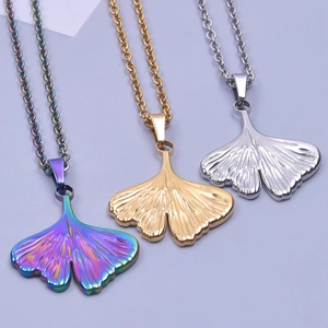 Detailed macro view of ginkgo leaf pendants in gold, silver, and iridescent finishes