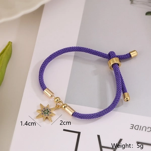 Detailed view of purple cord bracelet with 1.4cm gold-plated star pendant and zircon