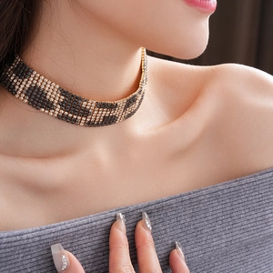 Detail of luxury rhinestone leopard print choker necklace on female model neck