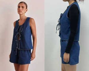 Detail of dark blue denim set featuring a sleeveless tie-front vest and high-waisted shorts