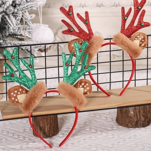 Close-up of glittery red and green reindeer antler headbands with plush details for Christmas