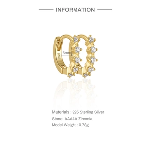 Macro detail of gold plated S925 sterling silver hoop earrings with 5 cubic zirconia stones