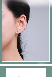 Close-up of minimalist S925 sterling silver hoop earring with a round-cut crystal on model