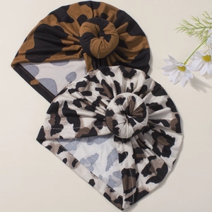 Two leopard print baby turban hats with top knots in dark brown and light gray shades