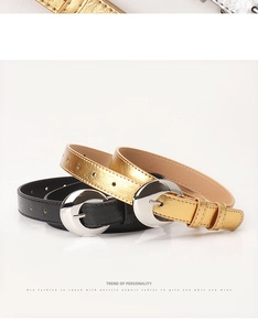 Detail shot of black and gold slim belts featuring silver half-moon metal buckles