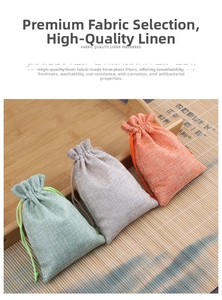Linen drawstring jewelry pouches in green, grey, and pink displayed on a wooden tray
