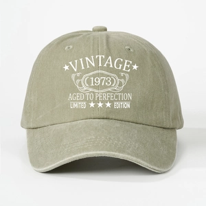 Close-up of Vintage 1973 printed text on washed cotton fabric of the baseball cap