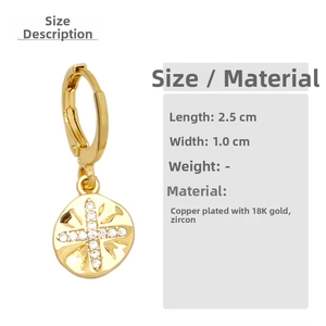 Detail showing 18K gold-plated copper earrings with cross-shaped zircon pendants