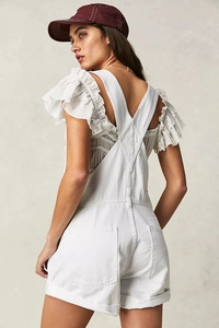 Detailed back view of white denim overalls showing racerback design and functional pockets
