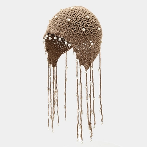 Handmade brown crochet beanie featuring white pearls and long tassel fringe detailing