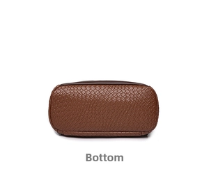 Detail shot of the reinforced oval base with dark brown woven texture on PU backpack