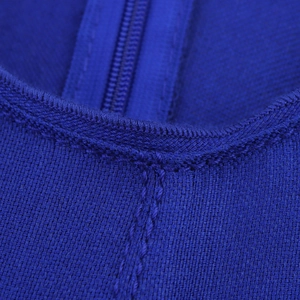 Detail of blue bandage dress featuring hidden zipper and textured knit fabric