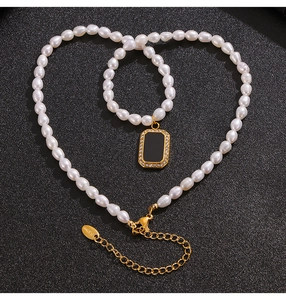 Macro view of pearl necklace with black rectangle pendant and lobster clasp details