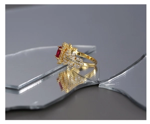 Macro shot of gold ring with marquise red gemstone and pave set cubic zirconia stones