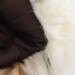 Close-up of fluffy leopard faux fur texture with white and brown plush fabric detail