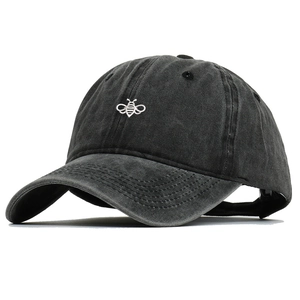 Close-up of fine bee embroidery on washed cotton fabric of this vintage baseball cap