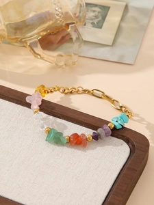 Close-up of bohemian stainless steel bracelet with colorful natural stones and gold beads