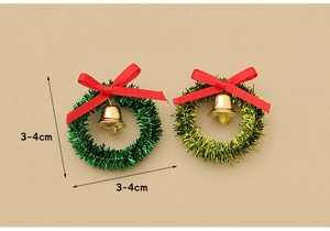 Detailed view of two mini Christmas wreaths with red bows and gold bells, size 3-4cm