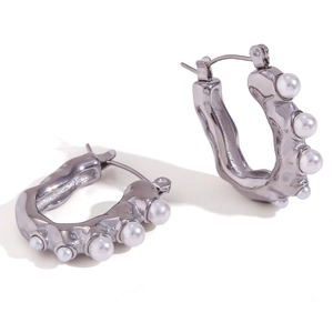 U-shaped silver liquid metal earrings with white pearls on a clean white background