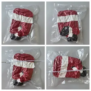 Macro view of plush Santa elf legs in vacuum packaging showing dimensions with a tape measure