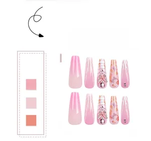 Detailed view of 10pcs set long coffin pink gradient press-on nails with 3D metal bows