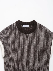 Detailed close-up of brown and beige herringbone knit pattern on a sleeveless vest top