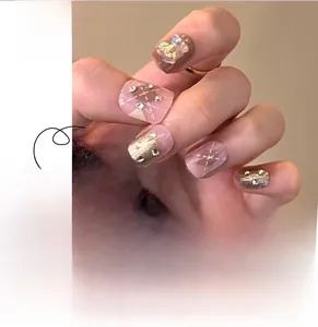 Detail of pink plaid press-on nails with 3D teddy bear, pearls and sparkling rhinestones