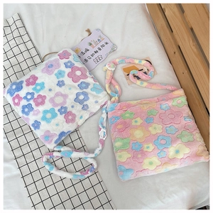Close-up of soft plush floral tote bags showing two colors and fuzzy material texture
