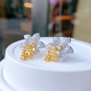 Luxury flower stud earrings with micro-paved white diamonds and yellow heart-shaped gems