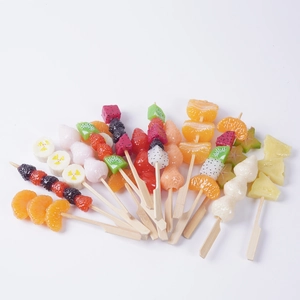 Realistic artificial fruit skewers featuring orange, strawberry and kiwi for decoration