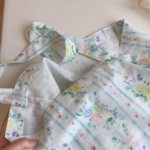Close-up of floral cotton tote bag with blue stripes and delicate pink rose patterns