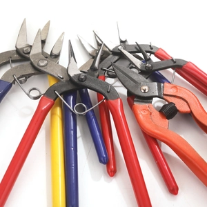Assorted DIY jewelry making pliers and round nose tools on a clean white background