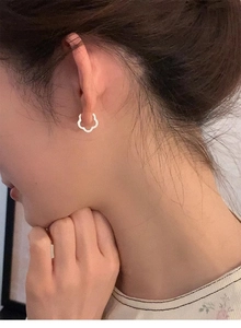 Close-up of a model wearing minimalist S925 silver hollow flower hoop earrings