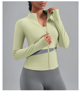 Detail of slim-fit sage green yoga jacket with gray contrast panels and high collar
