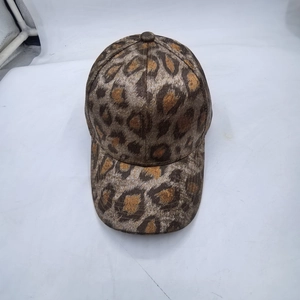Detailed top view showing the brown leopard print pattern and fabric texture of the baseball cap