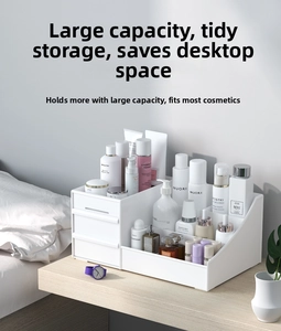 White desktop organizer with two drawers and compartments on a light wood desk