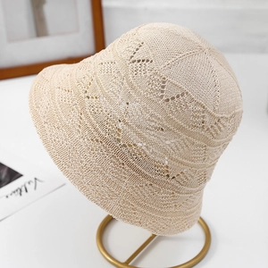 Close-up of the delicate hollow-out knitted texture of this beige bucket sun hat