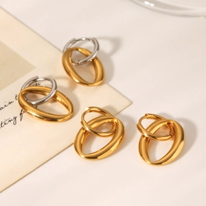 Detail of interlocking double hoop earrings in polished gold and silver two-tone finish