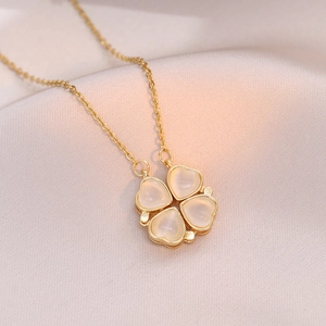 Vintage gold clover necklace featuring heart-shaped cat-eye stones on a delicate O-chain