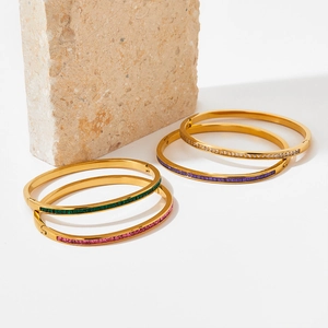 Gold stainless steel bangle set with colorful green, pink, purple, and white crystals