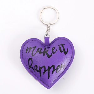 Close-up of purple PU leather heart keychain with Make It Happen text and silver ring