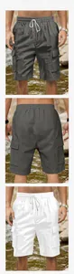 Detail of cargo shorts showing elastic drawstring waist and large side pockets on fabric