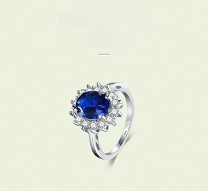 Detail of S925 silver ring featuring an oval deep blue gemstone with diamond halo