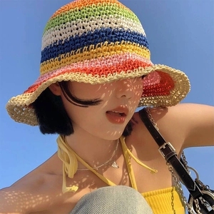 Rainbow knit straw sun hat with wide brim for UV protection shown against blue sky
